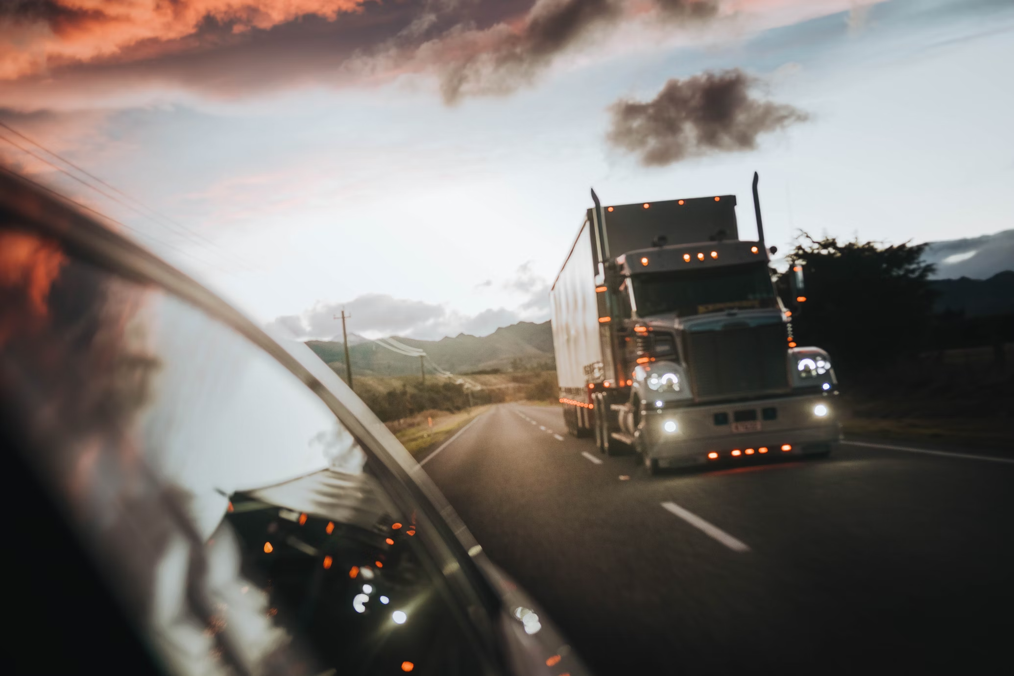 Cargo truck on the highway at dusk with IoT and GPS technology for logistics