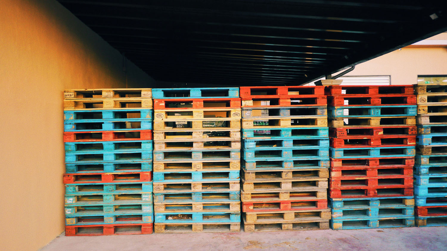 Stack of colorful wooden pallets ready for IoT tracking